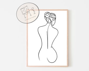 May include: Minimalist line art print of a woman's back, framed in a light wood. The black line drawing depicts the silhouette of a woman's back and hair. The artwork is on a white background. A small circular logo is in the upper left corner.