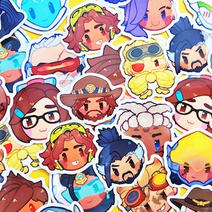 May include: A collection of colorful stickers featuring cartoon illustrations of various characters. The stickers have a white border and are arranged on a yellow background. The characters have different hairstyles, facial expressions, and accessories.