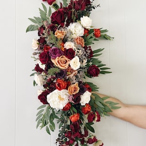 Wedding Arch Arrangements With Burgundy Rust Orange and Dark Purple faux flowers, rust orange and burgundy floral arbor arrangements, arch