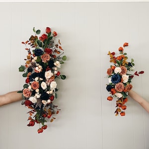 Wedding Arch Arrangements With Navy Blue and Rust Orange and Terracotta faux flowers, rust orange and navy blue floral arbor arrangements,
