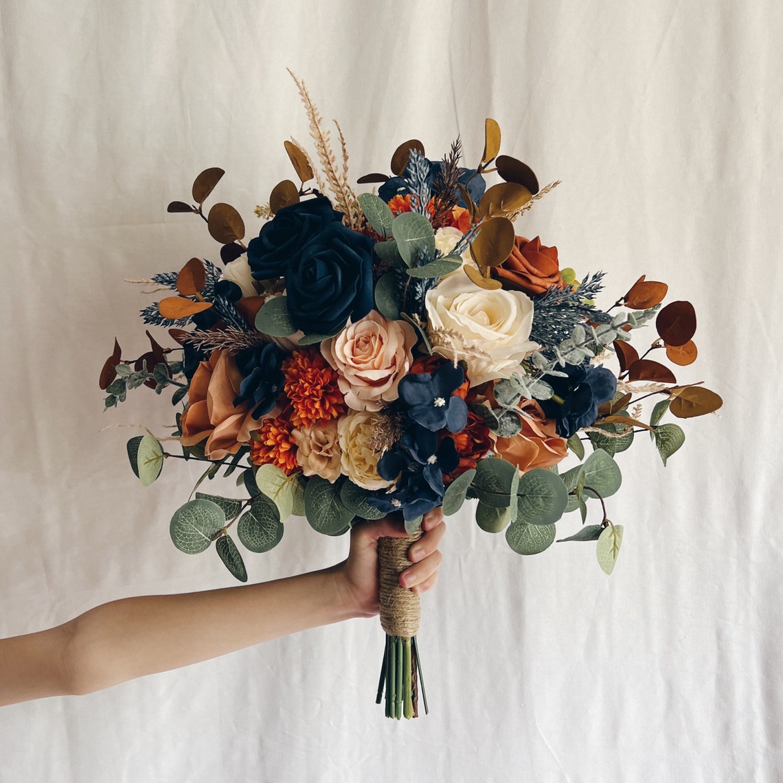 Wedding bouquet with navy blue and rust orange flowers image 1