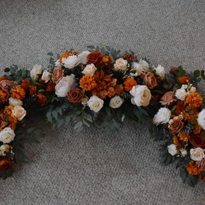 Wedding Arch Arrangements With Rust Orange and Terracotta faux flowers, burnt orange floral arbor arrangements, altar decor, fall wedding