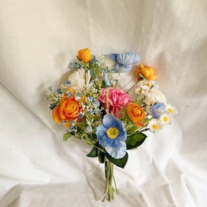 Bunch of faux flowers in blue, orange and hot pink colors for table decorating, wedding table centerpieces, wild flowers centerpiece, faux
