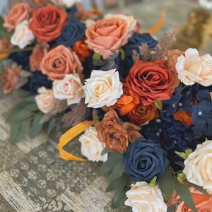 Wedding Table Arrangements With Navy Blue and Rust Orange and Terracotta faux flowers, rust orange and navy blue floral arbor arrangements