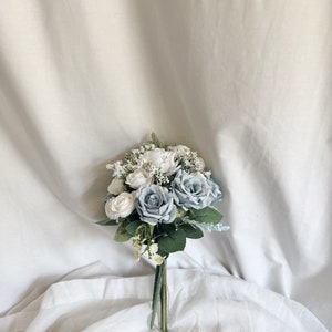 Bunch of faux flowers in dusty blue and white colors for wedding table decorating, wedding table centerpieces, blue  flowers centerpiece