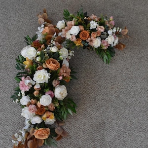 Wedding Arch Arrangements With Terracotta, Rust Orange, Dusty Rose and White faux flowers, rust orange and caramel floral arbor arrangements
