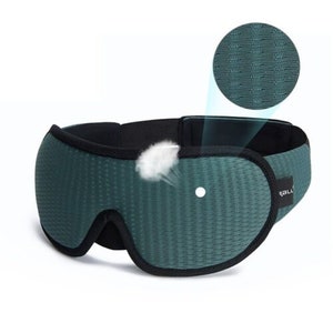 May include: Green sleep mask with a black adjustable strap and a breathable mesh fabric. The mask has a small hole for the nose.