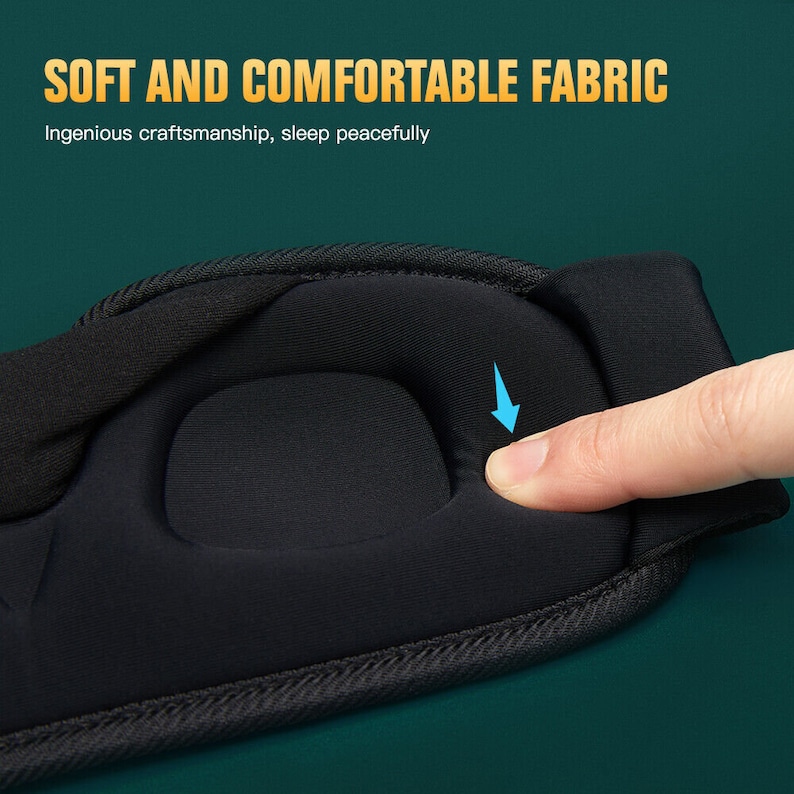 May include: Close-up of a black sleep mask with a soft, padded area. The padding is designed to provide comfort and support for the eyes.