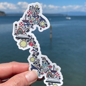 Sticker île de Whidbey avec des images de la mer des Salish : un ferry, des baleines, un phare, une orque, du soleil et bien plus !