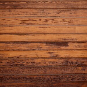 May include: A close-up of a wooden wall with horizontal planks. The wood is a rich brown colour with a slightly distressed finish. The planks are evenly spaced and create a rustic and natural look.