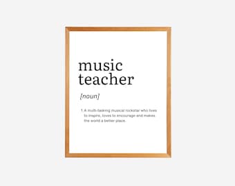 May include: A framed print with the word "music teacher" in bold black text. The definition below reads: "[noun] 1. A multi-tasking musical rockstar who lives to inspire, loves to encourage and makes the world a better place."