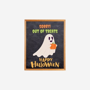 May include: A black chalkboard with a white ghost holding a pumpkin. The chalkboard says "Sorry! Out of Treats" and "Happy Halloween".