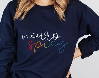 May include: Navy blue sweatshirt with the text "neuro spicy" written in rainbow colours.