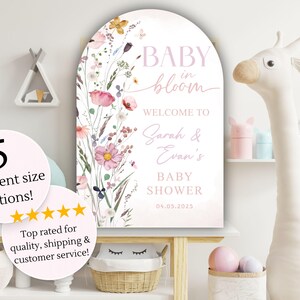 May include: A baby shower sign with a floral design and the words "BABY in bloom." The sign welcomes guests to Sarah & Evan's baby shower on 04.05.2025. The sign is available in 5 different size options.