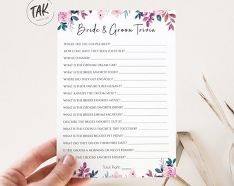 Może przedstawiać: Drukowana gra na wieczór panieński z kwiatowym wzorem. Gra nosi nazwę "Bride & Groom Trivia" i zadaje pytania o parę, takie jak: gdzie się poznali, jakie są ich ulubione potrawy i jakie są ich wakacje marzeń.