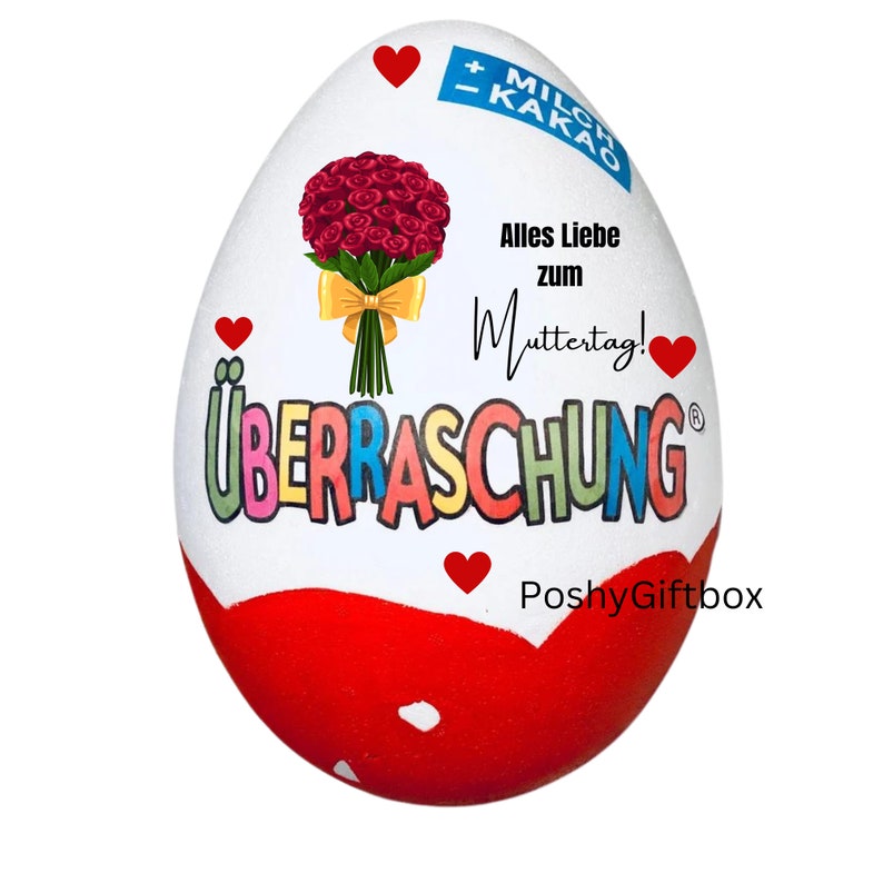 May include: A white chocolate egg with a red and white design. The egg has the words "&Uuml;berraschung" and "PoshyGiftbox" printed on it. The egg also has a bouquet of red roses and the text "Alles Liebe zum Muttertag!" printed on it.