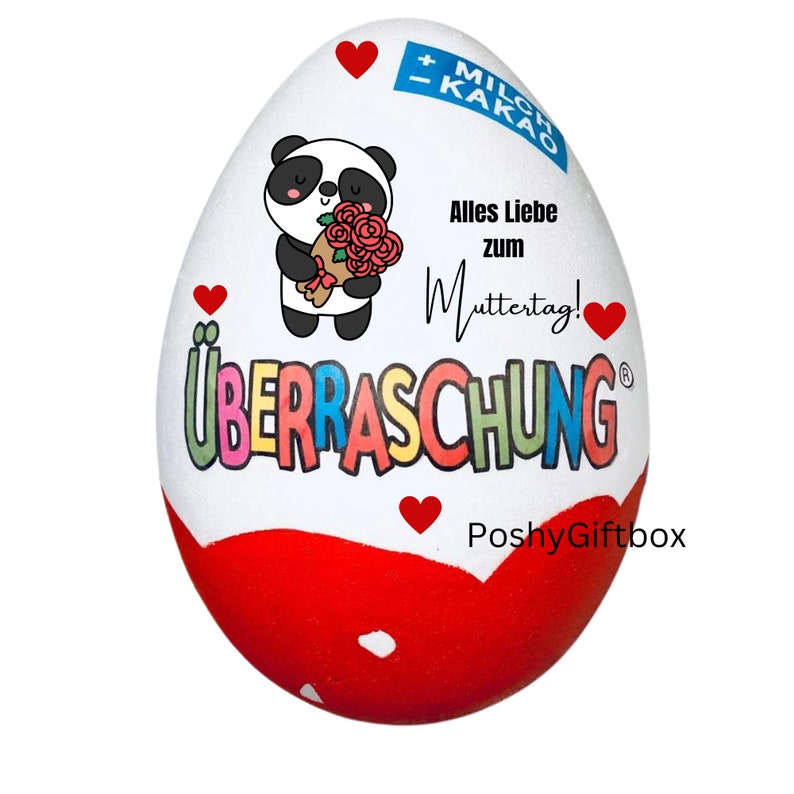 May include: A white chocolate egg with a red and white design. The egg has a panda bear holding a bouquet of red roses. The text on the egg says "Alles Liebe zum Muttertag!" and "&Uuml;BERRASCHUNG".
