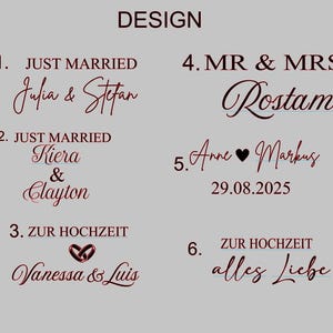 May include: A design layout featuring wedding-themed text in a dark red script. Phrases include "Just Married," "Mr & Mrs," and "Zur Hochzeit." Names and dates are also displayed, with a heart symbol. The word "DESIGN" is at the top.