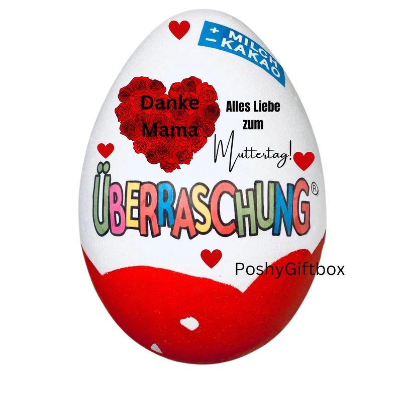 May include: A white chocolate egg with a red heart and the words "Danke Mama" inside the heart. The egg also has the words "Alles Liebe zum Muttertag!" and "PoshyGiftbox" printed on it.
