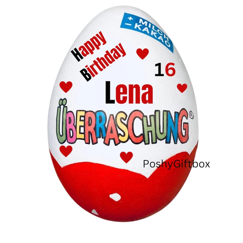 May include: A white chocolate egg with red, pink, and yellow text that reads "Happy Birthday Lena 16 &Uuml;berraschung" with a red heart design. The egg is decorated with red hearts and the text "PoshyGiftbox".