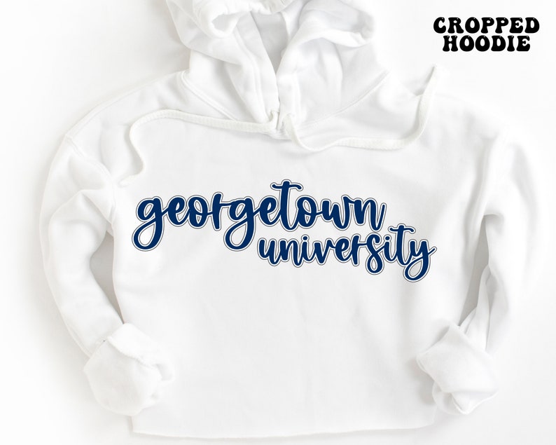 May include: White cropped hoodie with the text "georgetown university" in navy blue lettering.