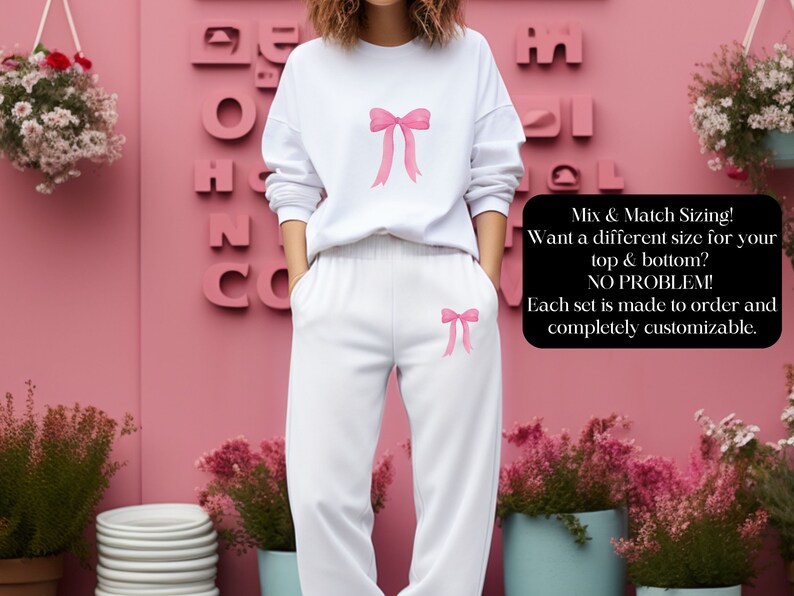 May include: White sweatshirt and sweatpants set with pink bows on the front. The text "Mix & Match Sizing! Want a different size for your top & bottom? NO PROBLEM! Each set is made to order and completely customizable." is on the right side of the image.