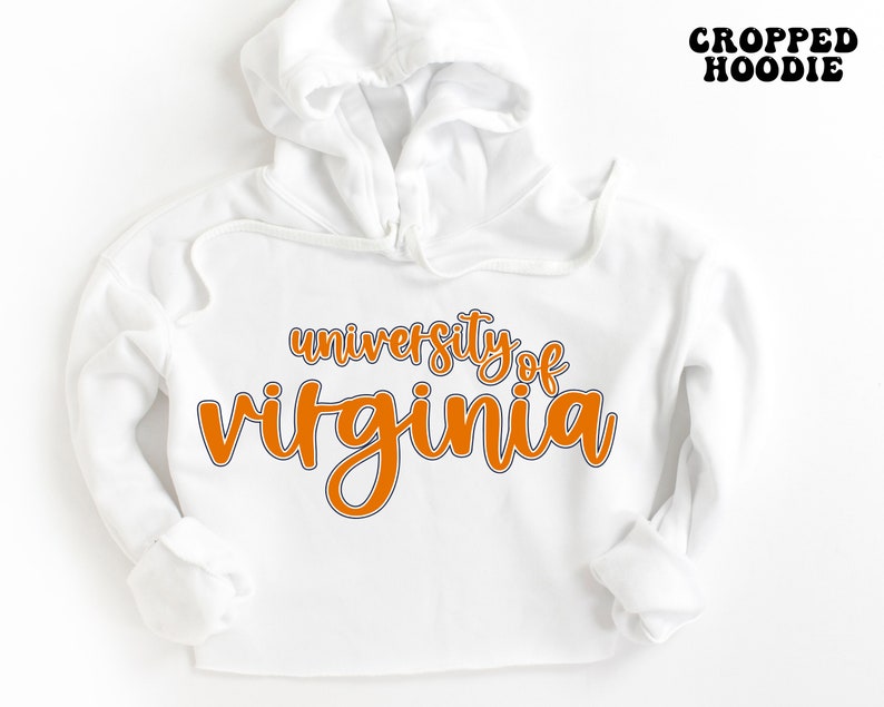 May include: White cropped hoodie with the text "university of virginia" in orange lettering.