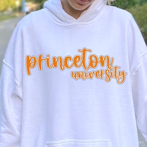 May include: White hoodie with an orange graphic that says "Princeton University" in a cursive font.