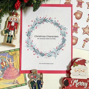 May include: A set of Christmas-themed activity printables for kids. The printables feature a watercolor wreath with red berries, a nutcracker, a ballerina, and a Santa Claus figurine. The text on the printables reads "Christmas Characters" and "An Activity Pack For Kids".