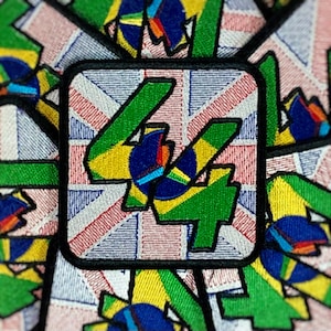 May include: A green and yellow embroidered patch with the number "44" on a Union Jack background.