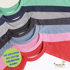 May include: A variety of colorful t-shirts are displayed, showcasing a range of hues including green, navy, gray, black, light blue, pink, and red. The shirts have crew necks and are made of 65% polyester and 35% cotton. The bottom right corner displays the Jumpin Jaks logo.