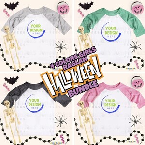 May include: Four raglan-style Halloween shirts in gray, green, black, and pink, each with a white body and colored sleeves. The shirts have a design area that says "YOUR DESIGN HERE". The image includes Halloween-themed decorations.