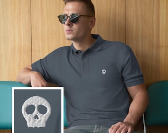 May include: Charcoal gray polo shirt with a white embroidered skull logo on the chest. The shirt has a classic collar and short sleeves. The image shows a person wearing sunglasses.