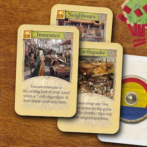 May include: A collection of board game components including three rectangular cards labeled Insurance, Neighbours, and Earthquake, featuring medieval illustrations and text, alongside several hexagonal terrain tiles and red wooden markers.