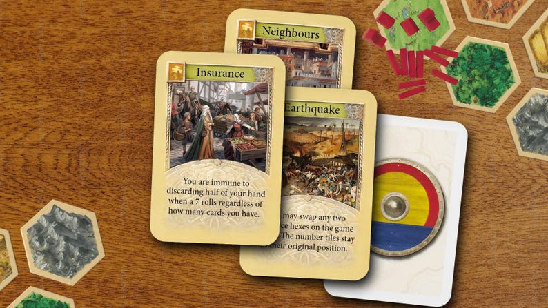 May include: A collection of board game components including three rectangular cards labeled Insurance, Neighbours, and Earthquake, featuring medieval illustrations and text, alongside several hexagonal terrain tiles and red wooden markers.