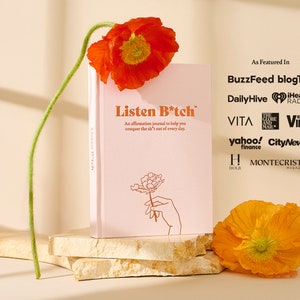 May include: A pink journal with the title "Listen B*tch" and a floral illustration. The journal is on a stack of beige stone coasters. The text "As Featured In" is above a list of publications and media outlets.