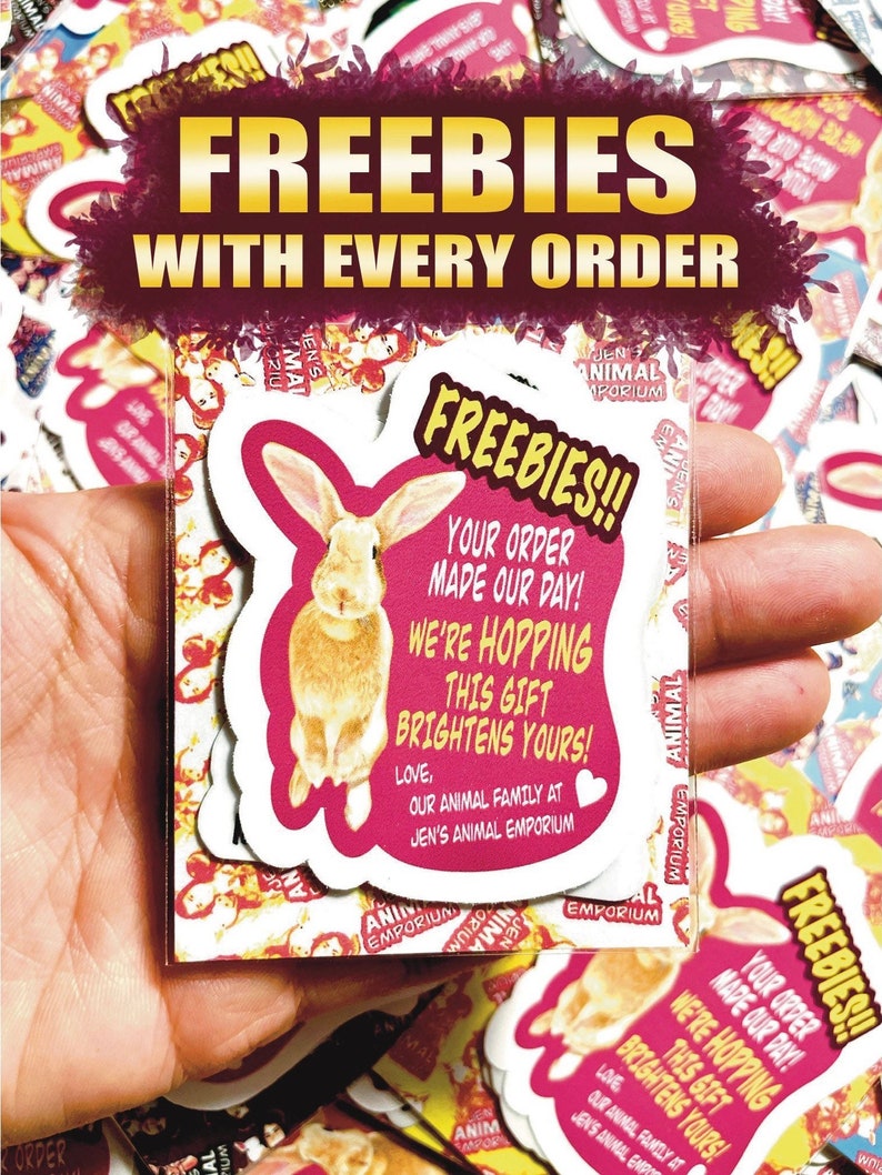 May include: A stack of pink and yellow stickers with a bunny rabbit illustration. The stickers say "Freebies!! Your order made our day! We're hopping this gift brightens yours! Love, our animal family at Jen's Animal Emporium."