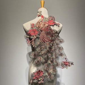 May include: A red and gold embroidered peacock design on a black mesh fabric. The peacock is detailed with sequins and beads.