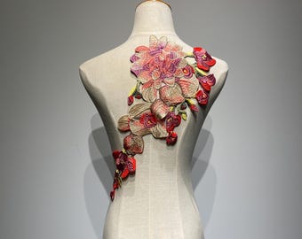 May include: A large floral applique with pink, red, and yellow flowers. The applique is made of embroidered fabric and is perfect for adding a touch of elegance to clothing or crafts.