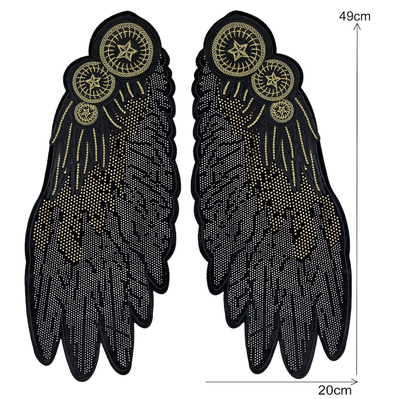 May include: A pair of black fabric wings with gold embroidered details. The wings are 49 cm tall and 20 cm wide.