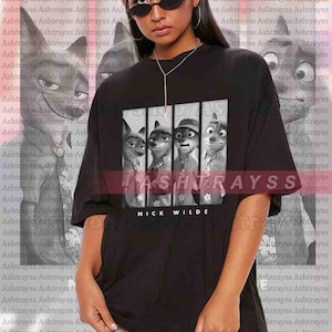 May include: Black unisex t-shirt featuring a graphic of characters from the animated film "Zootopia." The design includes Nick Wilde's name. The model is wearing a 2XL shirt.