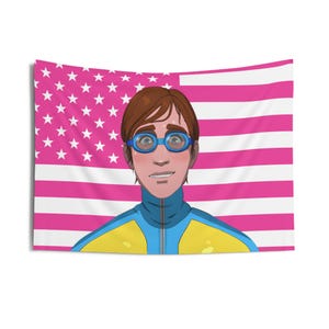 May include: A tapestry featuring a cartoon illustration of a person wearing blue goggles and a blue and yellow track suit. The background is a pink American flag with white stars and stripes.