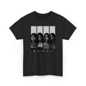 May include: Black t-shirt featuring a grayscale graphic of four women in vertical panels. The word "NIKKI" is printed in white block letters below the panels. The design is centered on the front of the shirt.