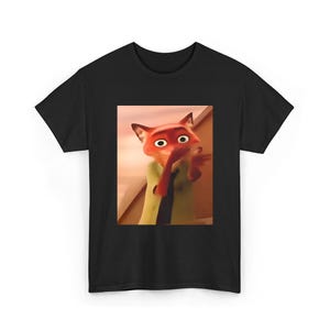 May include: Black t-shirt featuring a cartoon image of Nick Wilde from the movie Zootopia. The image shows Nick with a surprised expression, wearing a green shirt and red tie. The shirt is a classic crew neck style.