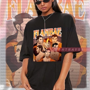 May include: Black unisex t-shirt with the word "FLAMBAE" in orange and yellow block letters. The shirt features a graphic of six men in a vintage style. The model wears a 2XL.