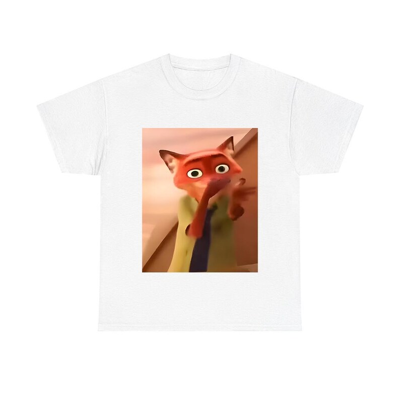 May include: White t-shirt featuring a cartoon image of Nick Wilde from the movie Zootopia. The image shows Nick with his hand up to his mouth. The shirt is a classic crew neck style.