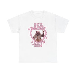 Puede incluir: Camiseta blanca con un corazón rosa que contiene el texto "BUT DADDY I LOVE HIM" y una ilustración de un perezoso. El perezoso lleva un traje y sostiene una taza de café.