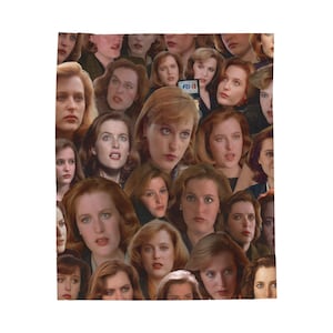 May include: A white blanket featuring a collage of faces, predominantly women with varying expressions. The faces are of a woman with red hair and blue eyes. The image includes a small sign that says "FBI".