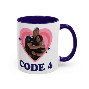 May include: White ceramic mug with a navy blue interior and handle. The mug features a pink heart design with a photo of two people embracing. The words "CODE 4" are printed in navy blue on the front.