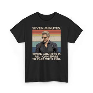 May include: Black t-shirt featuring a retro design with a man wearing sunglasses. The text reads "SEVEN MINUTES. SEVEN MINUTES IS ALL I CAN SPARE TO PLAY WITH YOU." The design has a vintage, distressed look.
